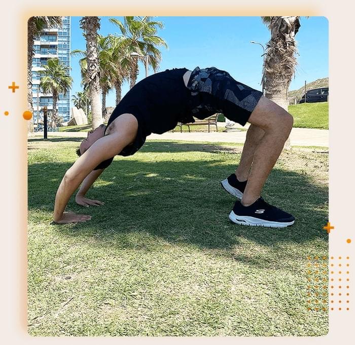 Mike practicing an advanced bridge pose outdoors, sharing his journey in flexibility training for the testimonial section